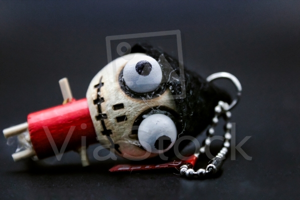 Small wooden keychain in the shape of a voodoo doll